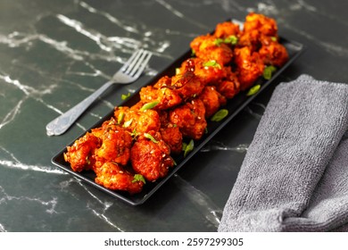 Gobi Manchurian is a crispy, spicy Indo-Chinese dish made with deep-fried cauliflower florets tossed in a tangy, savory sauce with garlic, soy, and chili.