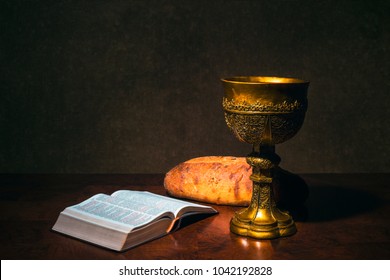 Goblet With Wine Bread And Holy Bible On A Table. The Last Supper.