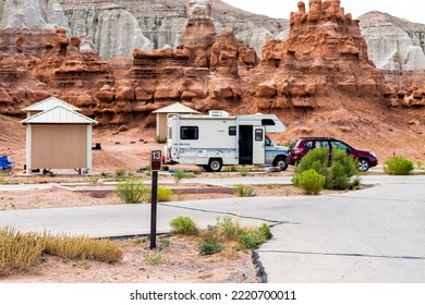 Goblin Valley, USA - August 10, 2019: White And Red Hoodoo Sandstone Rock Formations With Rv Camper Parked At Camp Site In Campground In Desert Landscape In Goblin Valley State Park