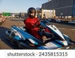 Go-cart racer moving fast on open air motor racing track