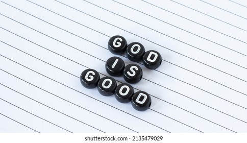 God Is Good, Text Written With Black Circle Letters Isolated On White Lined Paper. The Christian Biblical Concept Of The Goodness, Love, And Mercy Of God Jesus Christ. A Closeup.