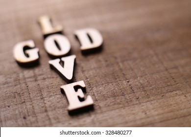 God Is Love Concept Text Lying On The Rustic Wooden Background.