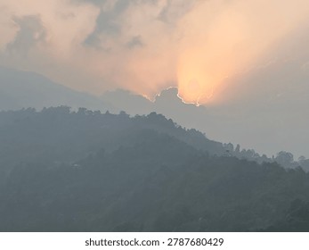 GOD RAYS

A dramatic sunset scene where the sun is partially obscured by a cloud, creating a distinct 