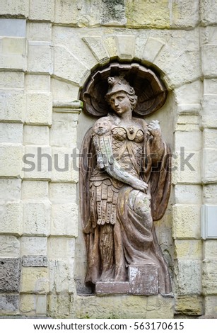 God statue on the stone wall at ancient castle in Saint Petersburg, Russia. Saint Petersburg is one of the world's youngest great cities.