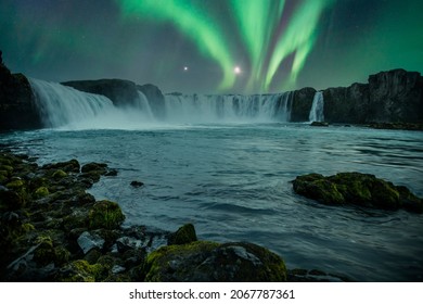 Godafoss waterfall on a night with a beautiful Northern Lights. Iceland