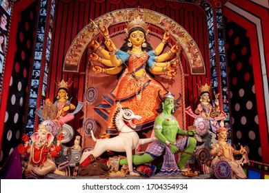 Goddess Durga idol at decorated Durga Puja pandal, shot at colored light, in Kolkata, West Bengal, India on October 2019