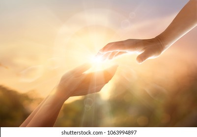 God's helping hand with the white cross on sunset background. Day of remembrance and good friday concept - Shutterstock ID 1063994897