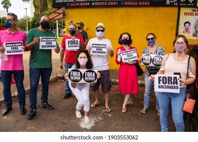 GOIANIA GOIAS BRAZIL - JANUARY 22 2021:  Demonstration calling for the impeachment of Bolsonaro. Several people, wearing a mask, holding signs with the text "Bolsonaro out!"