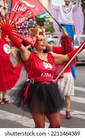 GOIANIA GOIAS BRAZIL - SEPTEMBER 28 2022: A Woman In Red Clothes Dancing In The Street. Photo Taken During A Performance In Favor Of The Presidential Candidate Of Brazil, Lula.