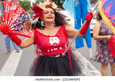 GOIANIA GOIAS BRAZIL - SEPTEMBER 28 2022: A Woman In Red Clothes Dancing In The Street. Photo Taken During A Performance In Favor Of The Presidential Candidate Of Brazil, Lula.