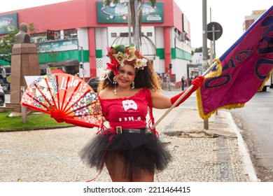 GOIANIA GOIAS BRAZIL - SEPTEMBER 28 2022: A Woman In Red Clothes Dancing In The Street. Photo Taken During A Performance In Favor Of The Presidential Candidate Of Brazil, Lula.