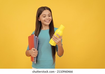 Going To Drink. Cheerful Kid With Juice Or Water And Books. Smiling Teenager Student.