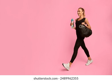 Going To Gym. Happy Fitness Girl Carrying Bag Walking Over Yellow Background. Full Length, Studio Shot