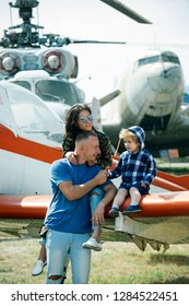 Going High. Air Travel. Family Vacation. Family Couple With Boy Kid On Vacation Trip. Mother And Father With Son At Helicopter. Helicopter Tour And Travel. Travelling By Air. Enjoying Travelling Fun.