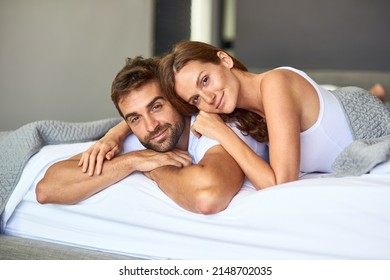 Going outside is so overrated. Shot of a happy young couple relaxing in bed together at home. - Powered by Shutterstock
