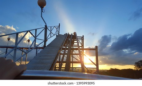 Going Up In A Roller Coaster At Sunset