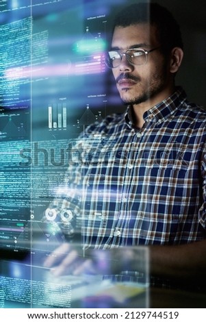 Going through the source code. Cropped shot of a young computer programmer looking through data.