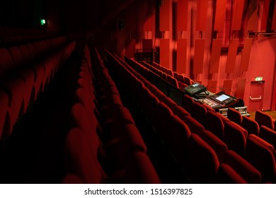 Goirle, Netherlands - 09-25-2019: Red Chairs In The Movie Theatre With The Sound Mixing Desk / Sound Monitor In The Middle.