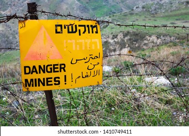 Golan Heights, Israel -January 17 2018: A warning sign for landmines in the fields.