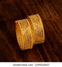 gold bangles with wooden background, beautifull jewellery - Shutterstock ID 2199216927