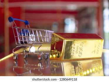 Gold Bar And Blue Mini Shopping Cart Blurry Shop Background Business Invests Concept