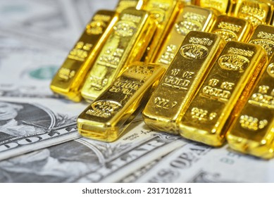 Gold bar lean against each other on the USD bills. Gold is hard commodity good, risk asset, tangible value that used to be gold reserve, and fund reserve. safe assets during war and  economic crisis. 