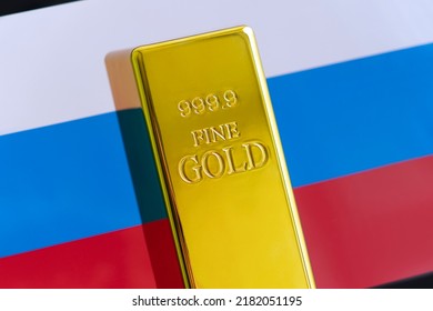The gold bar is on the national flag of russia. russian Gold Reserve concept - Shutterstock ID 2182051195