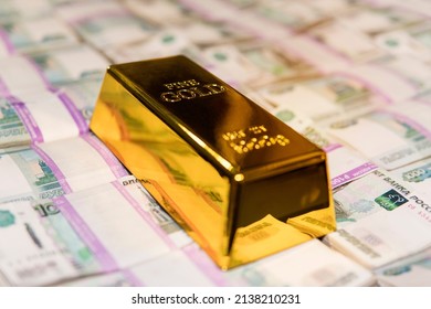 gold bar on russian money background with 1000 rubles banknotes. gold and foreign exchange reserves