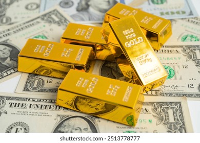 Gold bar on US dollar banknotes, finance and economy.
