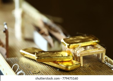 Gold bar put beside lifeboat on ship model scene.