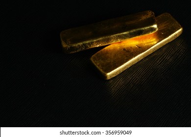 The Gold Bar Put On The Black Color Leather Surface Background Represent The Business And Finance Concept Related Idea. 