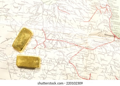 Gold Bar Put On Old And Vintage Paper Map Represent The Detail Of City Name And Destination And Concept Idea Of Wealth.        