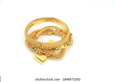 Gold Bars And Gold Bracelets Isolated On White Background.