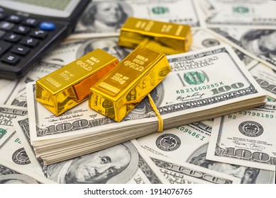 gold bars and calculator on 100 new US dollar banknotes. business and finance concept - Shutterstock ID 1914076765