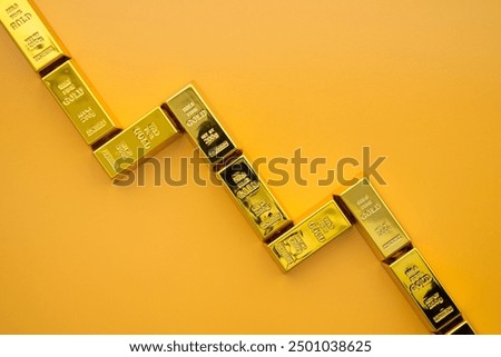 Gold bars as graph chart falling down on yellow background. Gold price are falling in commodity trading bear market, investment, risk management concept. Lower demand in recession economy crisis.