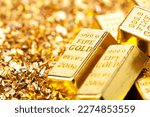 Gold bars on nugget grains background, close-up