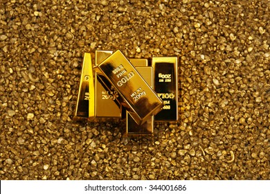 Gold Bars On Nugget Grains Background, Close-up, Top View