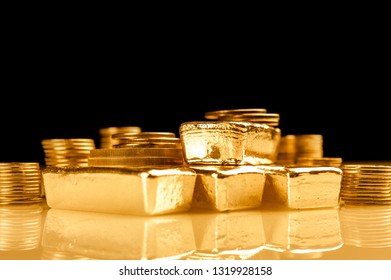 Gold Bars And Stack Of Gold Coins. Background For Finance Banking Concept. Trade In Precious Metals.