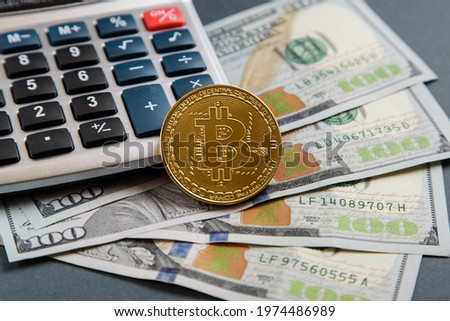 Gold bitcoin coin, dollar bill Black electronic calculator. Crypto Investing cryptocurrency exchange money. 