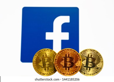 Gold Bitcoin Coins With The Facebook Logo On Background Screen. TOKYO, JAPAN - JULY 4, 2019