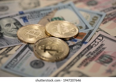 Gold Bitcoin Coins On Dollar Banknotes. Golden Cryptocurrency Coin On US Dollar Bills. Digital Money And Physical Government Currency.