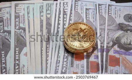 gold bitcoin coins on stack of US dollar bills on black background. finance and savings concept