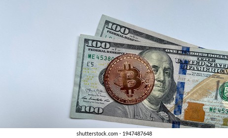 Gold Bitcoin Digital Currency With US 100 Dollars Banknote On White Background. Concept Photo.