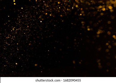 Gold bokeh of lights on black background - Shutterstock ID 1682090455