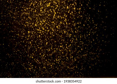 Gold Bokeh Of Lights From Water On Black Background