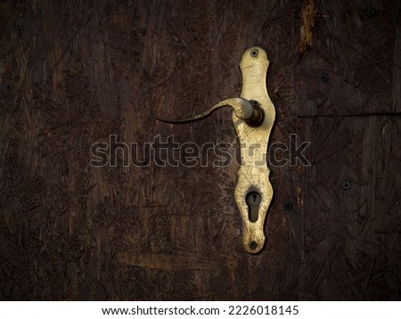 gold bow and keyhole on brown background, retro touch, old vintage style, atmosphere of mystery, lock dor secret      