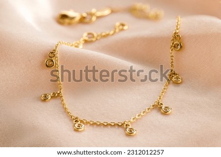 Gold  bracelet with diamond on pink background. Romantic jewelry. Advertising still life product. 