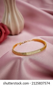 Gold bracelets jewelry on a gold background. Gifts for Valentine's Day Joyful girlfriends, women and wives pure pink and gold background.