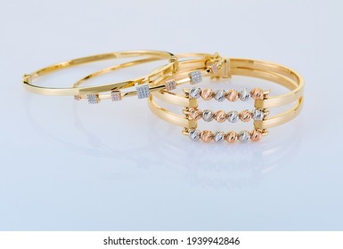 Gold Bracelets On Grey Background