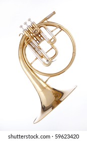 A Gold Brass Antique French Horn Or Peckhorn Isolated Against A White Background.